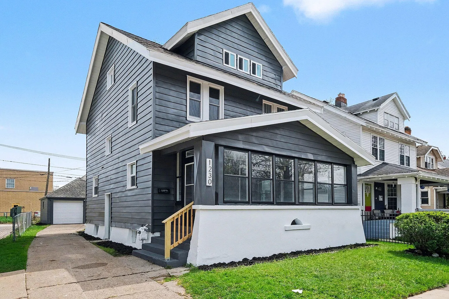 Completed gray two-story rehab with screened porch